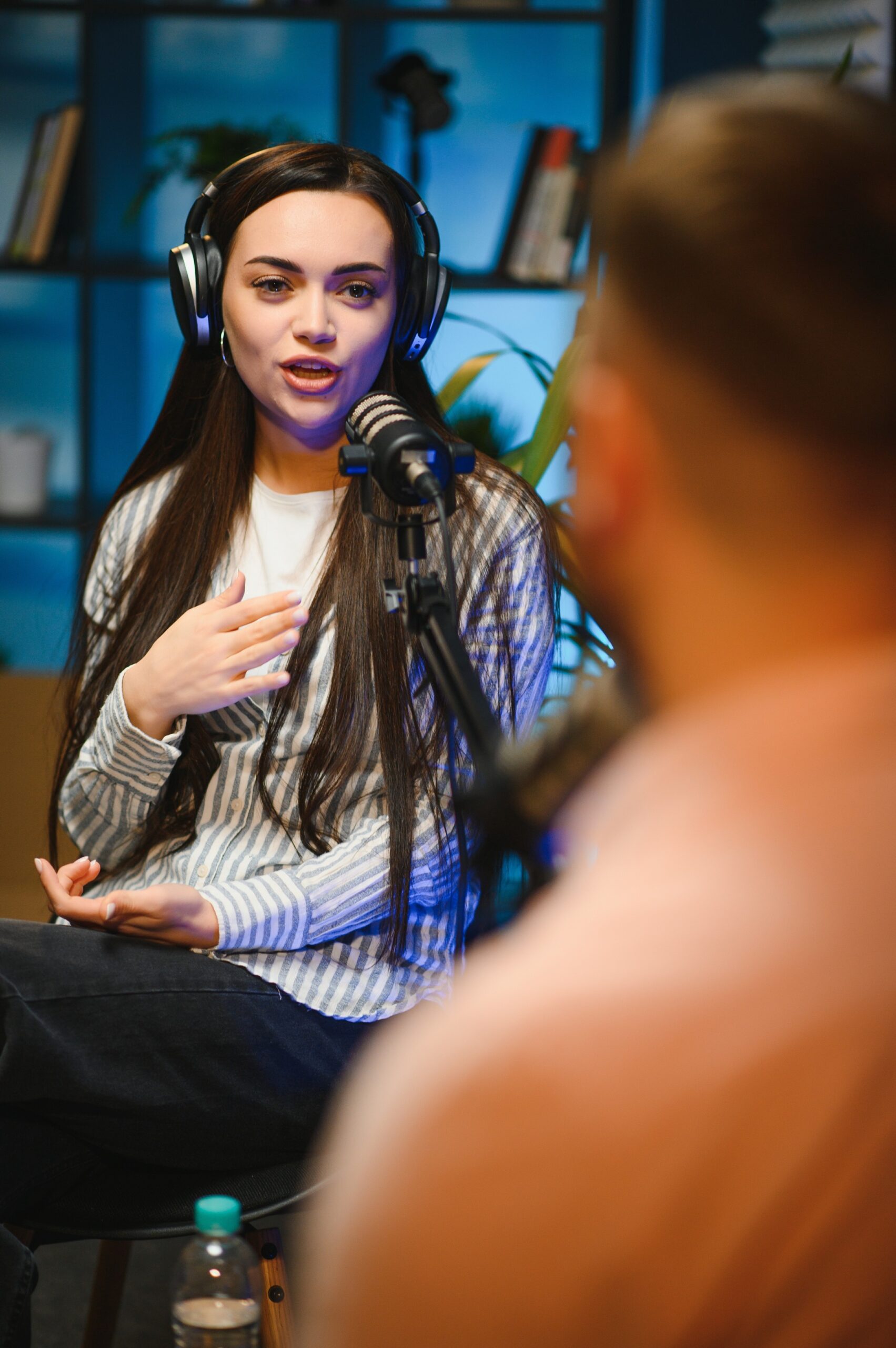 Show host interviewing woman during live stream, talking about fashion and style trends, disagreeing with her opinions. Man arguing with social media celebrity, recording podcast.